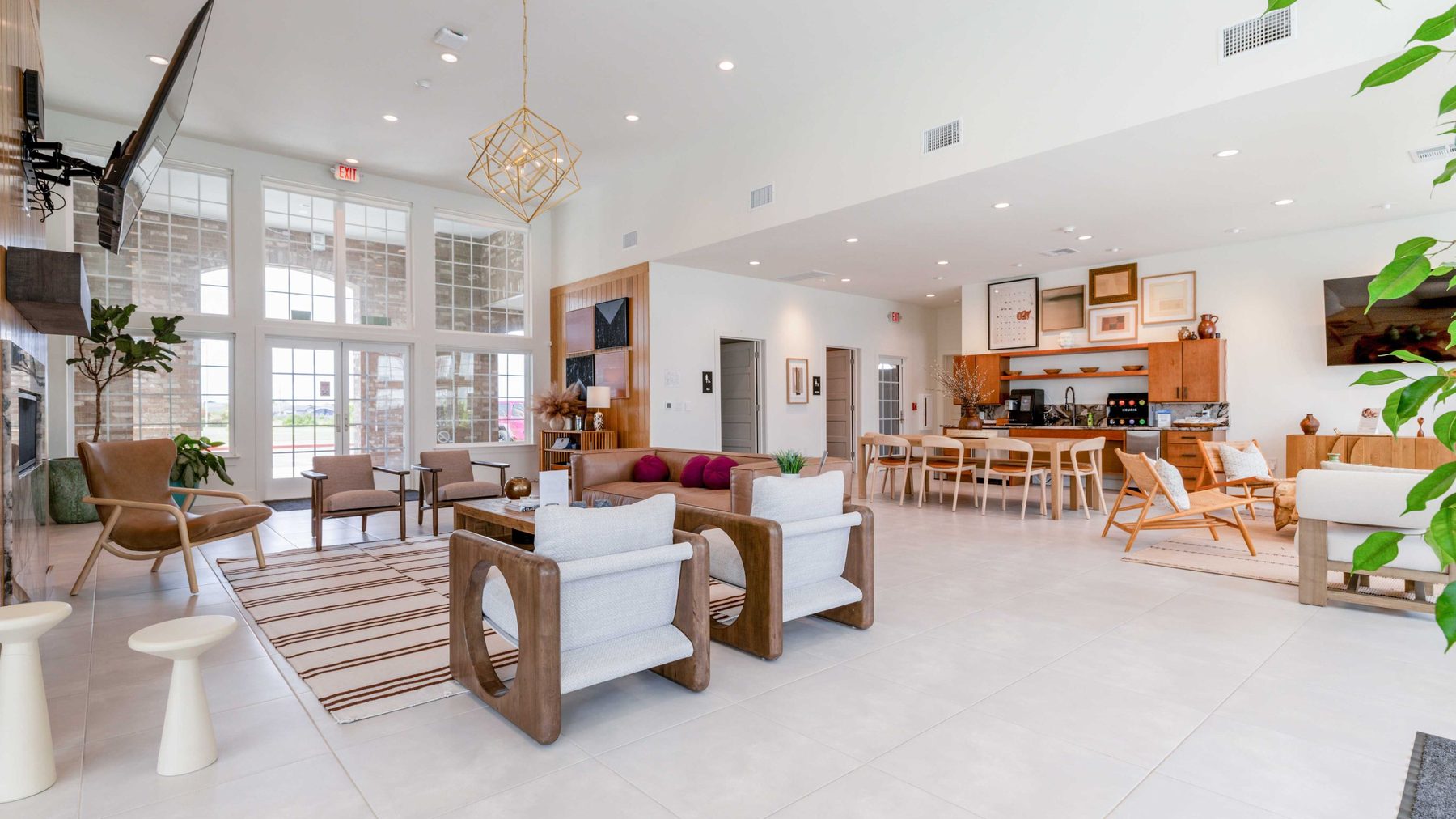 Completed multi-family clubhouse interior with open lobby, seating, and kitchenette