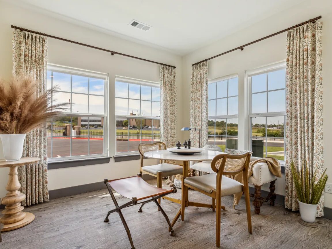 Multi-family amenity sitting room with windows and finished walls